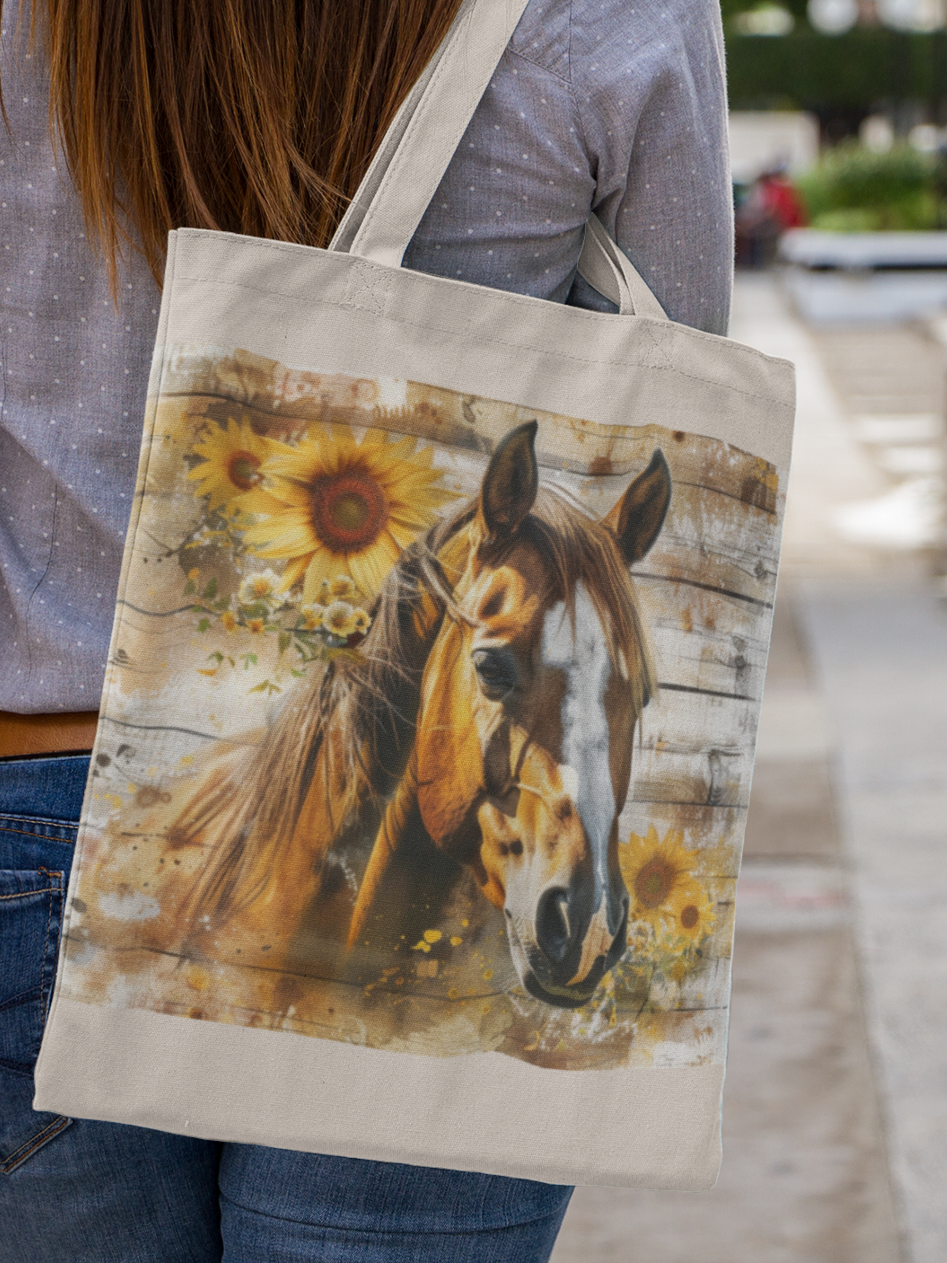 Woman holding a Canvas tote bag with majestic brown horse with white stripe down nose. Horse is surrounded by sunflowers, on a rustic barnwood background.